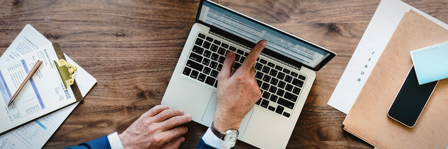 hand pointing at laptop