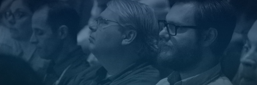 crowd of people looking toward an offscreen speaker