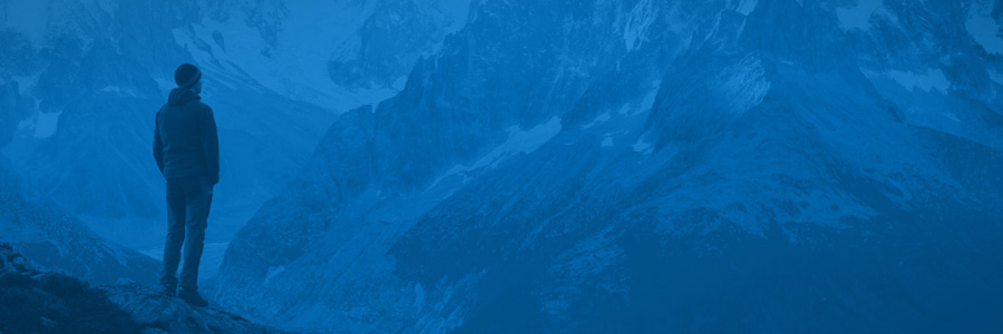 person staring at mountain range